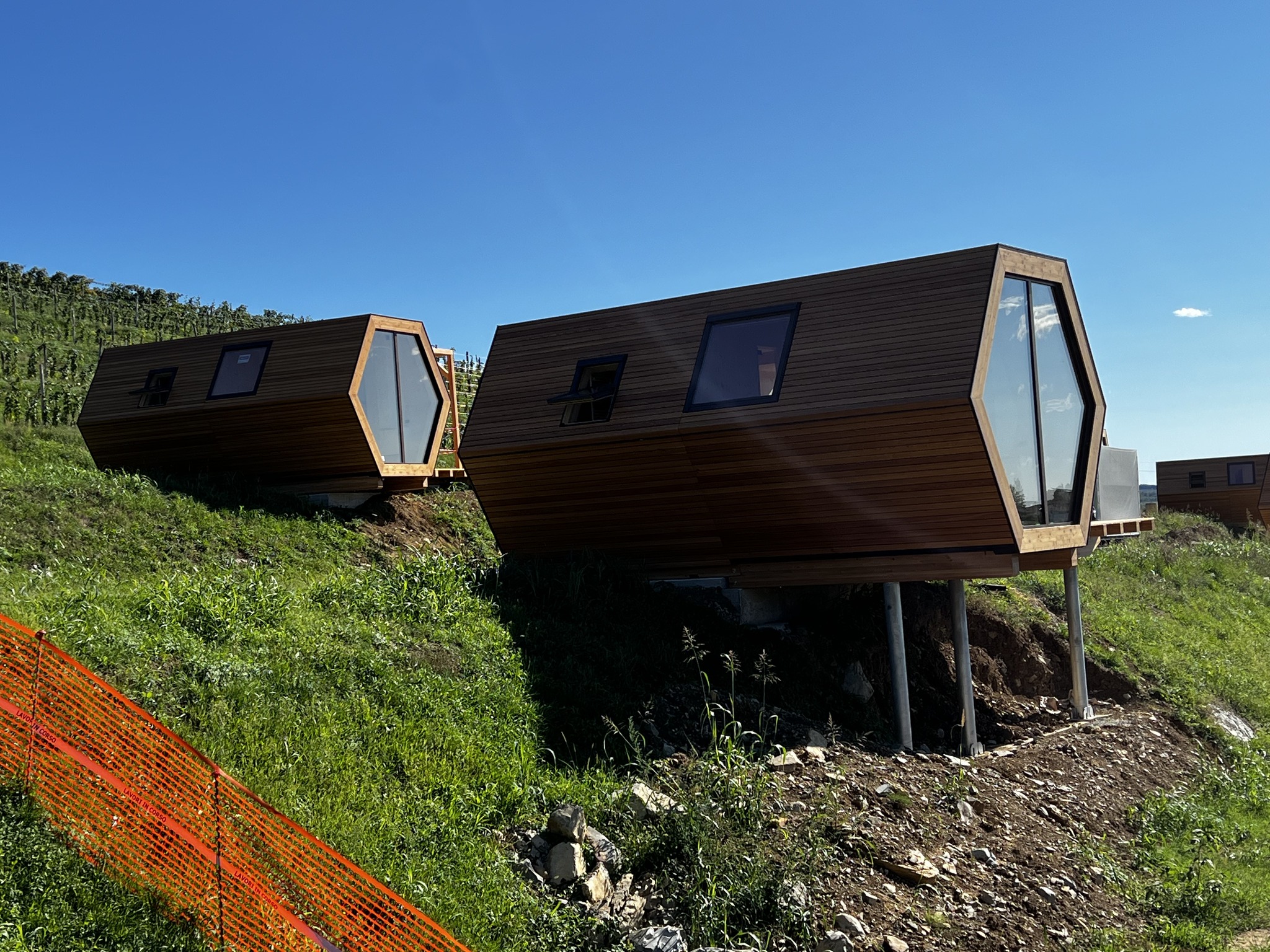 Hexagonal modular pods installed on hillside with stilts